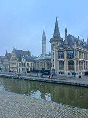 Ghent, Belgium. Old historic building near the river Leie on a foggy autumn day.