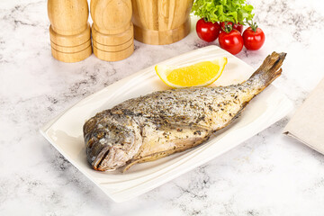 Baked Dorado fish served lemon