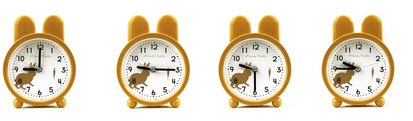 close up of a set of cute brown alarm clocks showing the time; 9, 9.15, 9.30 and 9.45 p.m or a.m....