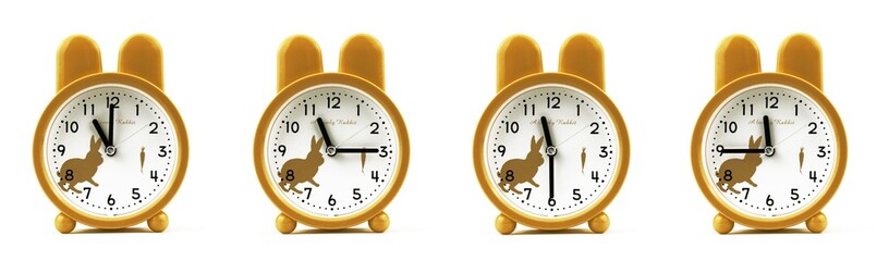 close up of a set of cute brown alarm clocks showing the time; 11, 11.15, 11.30 and 11.45 p.m or...