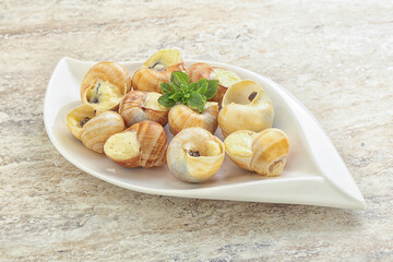 Naklejka na ściany i meble Delicous baked snail with butter - Escargot