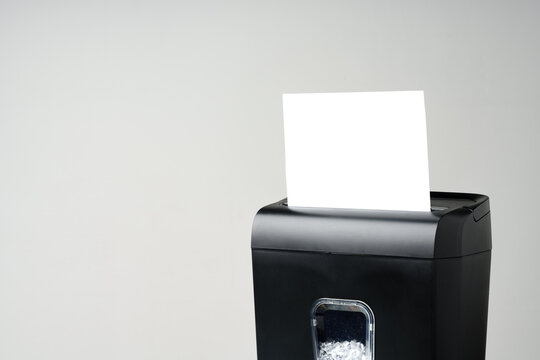 Office paper shredder on table against gray background