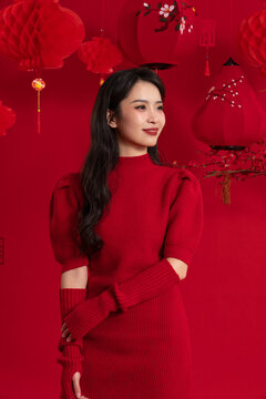 New Year atmosphere, a young Asian woman celebrating the New Year against a red background