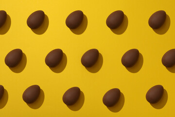 Delicious chocolate egg on a yellow background