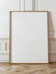 photo of a large blank frame leaning against a white wall. Frame is wood. resting on wooden parquet, close up, photo taken straight ahead 