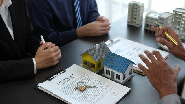 Young family, couple, client, calculate, sign a loan, explain the investment contract. Buy and sell deals before the meeting. Bank managers, agents, make financial deals. Buy home or condo insurance.