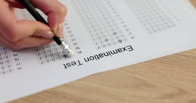 Student erases wrong answer on exam form with light eraser