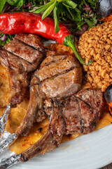 lamb chops with various vegetables at a fine dining restaurant