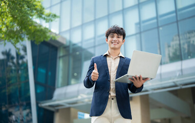 Fototapeta premium Portrait of young Asian businessman outside
