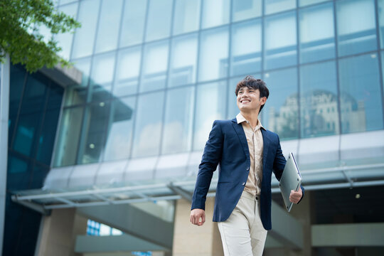 Portrait of young Asian businessman outside