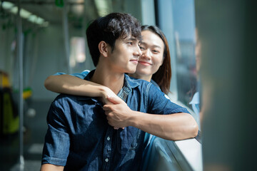 Photo of young Asian couple hang out together