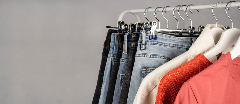 Jeans on a hanger. Casual wear. Modern, youth women's denim trousers. Shopping in the store.