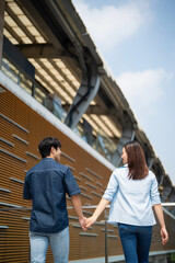 Photo of young Asian couple hang out together