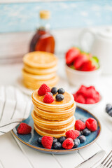 Homemade classic american pancakes with blueberries, raspberries and strawberries.