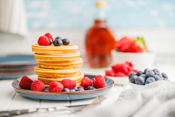 Homemade classic american pancakes with blueberries, raspberries and strawberries.