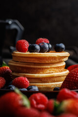 Homemade classic american pancakes with blueberries, raspberries and strawberries.