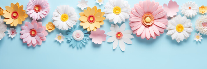 Colorful paper craft flowers on pastel blue background top view