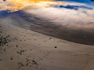 glare and reflections on the water. the sky is reflected in the water. Background of waves,...
