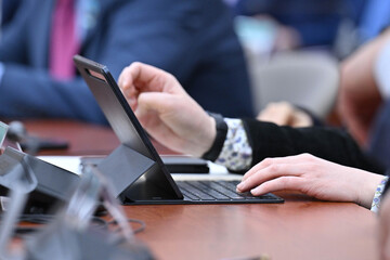 close up of a person typing on a digital tablet