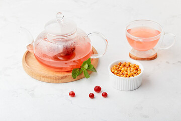 Vitaminized healthy tea with cranberry, mint and sea buckthorn. Organic natural drink.