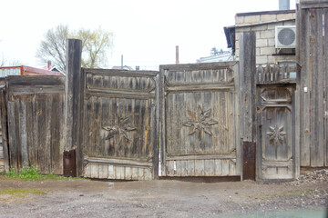old wooden gate in a dilapidated warped village, Russian outback