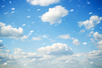 Fototapeta premium Clouds on blue sky at snowfall.