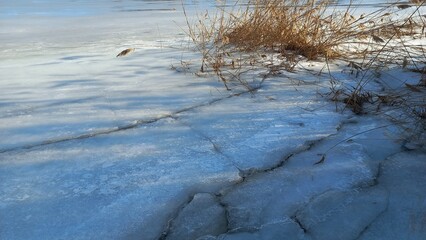 ice texture. icicles. winter. winter weather. stilt and snow. cracks in the ice. frozen water. transparent ice.