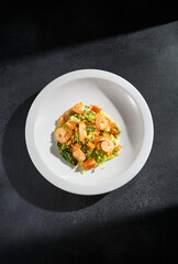 Top view of a shrimp salad with quinoa and mixed greens, a light and refreshing meal