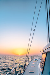 A beautiful sailing yacht sailing in sea with sunset