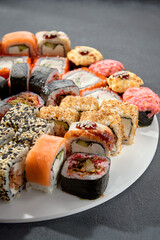 Classic and baked sushi rolls assortment; Philadelphia rolls topped with spicy sauce, a mix of warmth and tradition