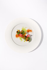 Top view of a crunchy crabmeat roll on a sleek white dish with a lime twist, perfect for upscale...