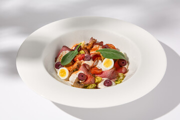 Roast Beef Salad with Quail Eggs and Vegetables on Shadowed White Presentation