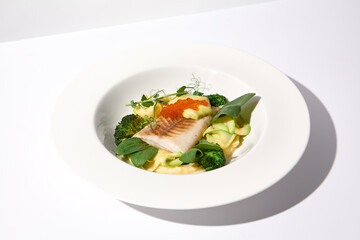 Cod Fillet with Red Caviar and Zucchini and Broccoli Garnish on White, an Elegant Dish for Fine Dining
