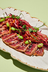 Close-up of tuna tataki with julienne vegetables and sesame seeds, a macro showcase of healthy gourmet dining