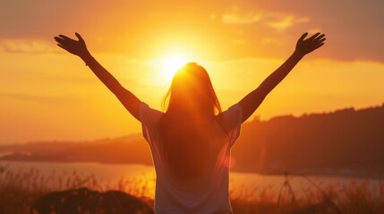 Fototapeta premium Woman Embracing the Sunset with Open Arms