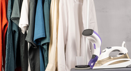 Clothes steamer and steam iron. Housework concept.