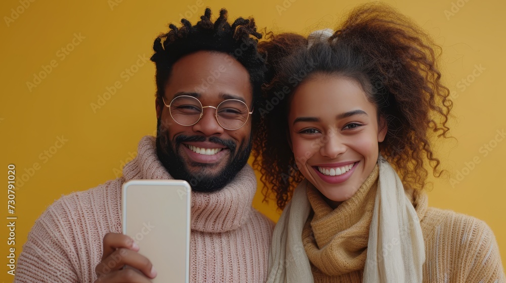 Poster it's a mobile offer in which a happy indian couple points at a big cell phone with white screen and 