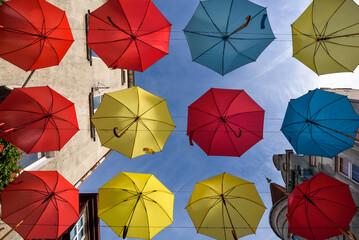 CITY LANDSCAPE - Tenement houses and colorful umbrellas against the blue sky  © Wojciech Wrzesień