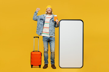 Traveler winner fun man wear denim casual clothes hold bag passport ticket big huge blank screen...