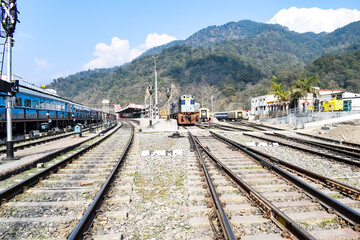 View of train Railway Tracks from the middle during daytime at Kathgodam railway station in India, Toy train track view, Indian Railway junction, Heavy industry