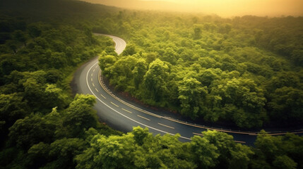 Aerial view beautiful curve road on green forest in the rain season.