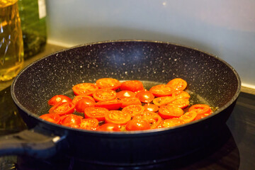 A cherry tomatoes baked in olive oil in a pan, healthy dietary food, diet.