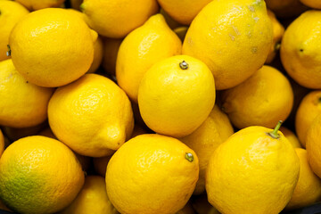 Ripe Yellow Lemons Close-up Background Or Texture. Lemon Harvest, Many Yellow Lemons in the store