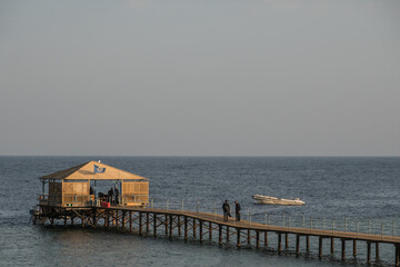 jetty with a diving base and a boat at the red sea