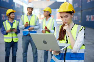 factory worker or engineer working on laptop computer in containers warehouse storage
