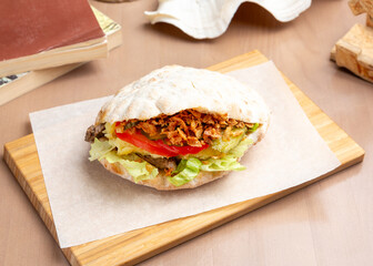 Sandwich with roast beef, tomato and fried onions on a homemade bun. Breakfast