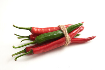 Red chilis and green chilis isolated on white background. Concept of strength through unity, where different elements come together to create a powerful and harmonious whole.