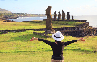 Female Traveler at the Amazing Ahu Tahai Ceremonial Platform on Pacific Coast of Easter Island,...