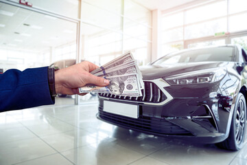 the buyer keeps the money to buy a new car in the salon, the realization of a dream. Buy  rent auto