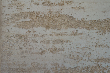 Closeup of beige semi-smooth wall with stucco lace finish